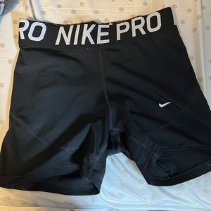 black nike pros, size medium, staining on the inside,fairly worn